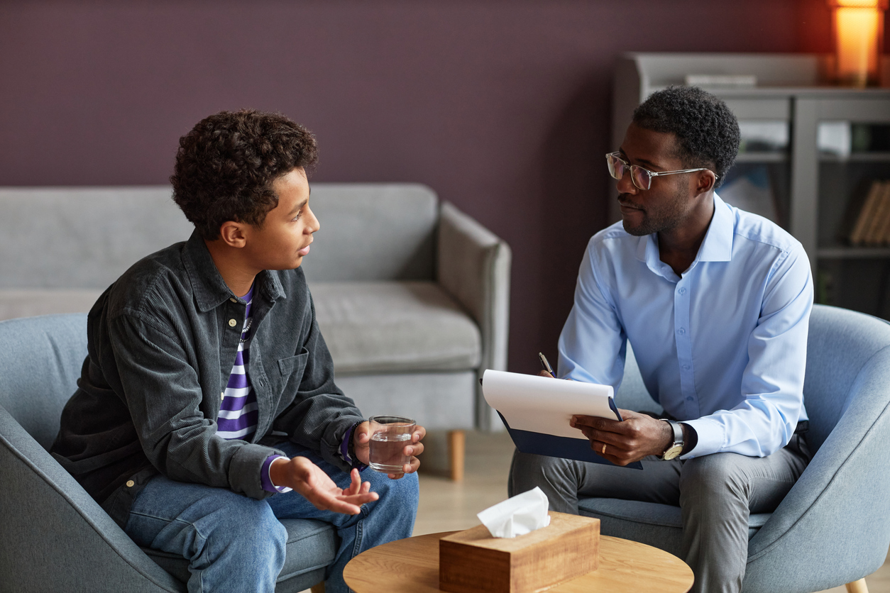 Boy Talking to Adolescent Psychologist